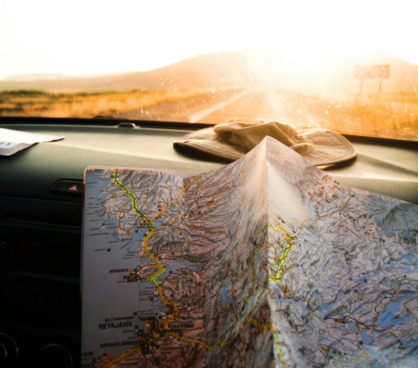 person holding blue and brown map