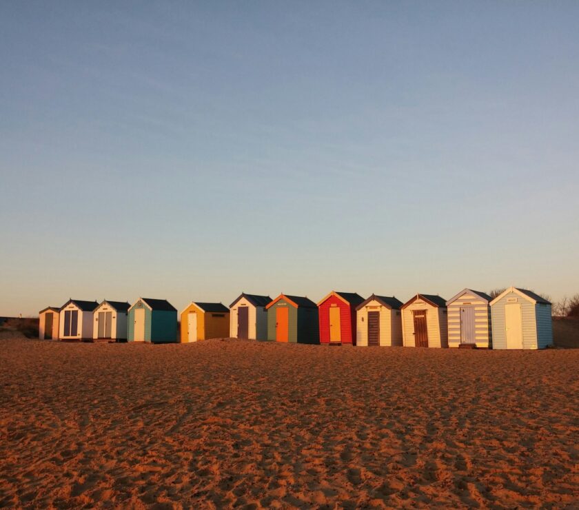 wooden sheds on desert during daytime